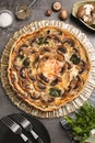 Delicious quiche with mushrooms and ingredients on dark grey table, flat lay Royalty Free Stock Photo