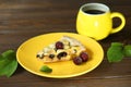 Delicious Quiche pie with cherry filling on yellow plate with cup of coffe