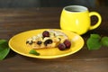 Delicious Quiche pie with cherry filling on yellow plate with cup of coffe