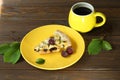 Delicious Quiche pie with cherry filling on yellow plate with cup of coffe