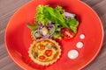 Delicious quiche with salad, served in colorful crockery Royalty Free Stock Photo