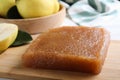 Delicious quince paste on wooden board closeup