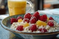 Delicious raspberry oatmeal with milk and fresh orange juice at a cozy street cafe