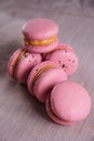 delicious raspberry pink macaroons set on napkin on table. close up view