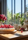 Delicious raspberry tart with cream in a beautiful cozy kitchen on a sunny day
