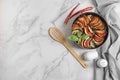 Delicious ratatouille, chili peppers and spatula on white marble table, flat lay. Space for text Royalty Free Stock Photo