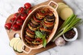 Delicious ratatouille and ingredients on white marble table, top view Royalty Free Stock Photo