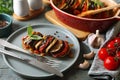 Delicious ratatouille served with basil on grey wooden table, closeup