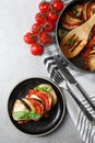 Delicious ratatouille served with basil on light grey table, flat lay