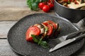 Delicious ratatouille served with basil on table, closeup