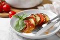 Delicious ratatouille served with basil on white marble table, closeup