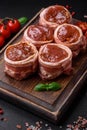 Delicious raw fresh pork or chicken meat rolls wrapped in bacon Royalty Free Stock Photo