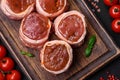 Delicious raw fresh pork or chicken meat rolls wrapped in bacon Royalty Free Stock Photo