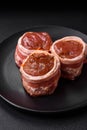 Delicious raw fresh pork or chicken meat rolls wrapped in bacon Royalty Free Stock Photo