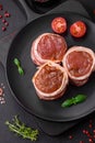 Delicious raw fresh pork or chicken meat rolls wrapped in bacon Royalty Free Stock Photo