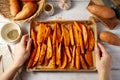 Delicious raw sweet potato wedges, fries on a baking pan. Royalty Free Stock Photo