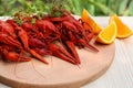 Delicious red boiled crayfish and orange on white wooden table, closeup Royalty Free Stock Photo