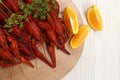 Delicious red boiled crayfish and orange on white wooden table, top view Royalty Free Stock Photo