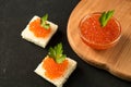 Delicious red caviar on wheat bread served with parseley on wooden desk Royalty Free Stock Photo