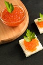 Delicious red caviar on wheat bread served with parseley on wooden desk Royalty Free Stock Photo