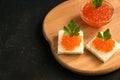 Delicious red caviar on wheat bread served with parseley on wooden desk. Copy space for your text Royalty Free Stock Photo