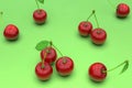 Delicious red cherries on green background Royalty Free Stock Photo