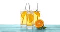 Delicious refreshing drink with orange slices on blue wooden table against white background Royalty Free Stock Photo