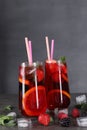 Delicious refreshing sangria, ice cubes and berries on grey table Royalty Free Stock Photo