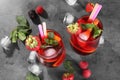 Delicious refreshing sangria, ice cubes and berries on grey table, above view Royalty Free Stock Photo