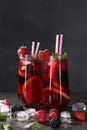 Delicious refreshing sangria, ice cubes and berries on grey table Royalty Free Stock Photo
