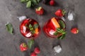 Delicious refreshing sangria, ice cubes and strawberries on grey table, flat lay Royalty Free Stock Photo