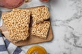 Delicious rice crispy treats on white table, flat lay. Space for text Royalty Free Stock Photo