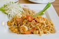 Delicious rice noodles with shrimp close-up on a plate. Thai Dis