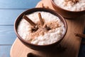 Delicious rice pudding with cinnamon and anise in bowl on wooden board Royalty Free Stock Photo