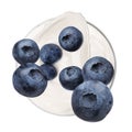 Delicious ripe blueberries falling into bowl with yogurt on background, top view