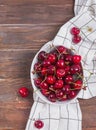 Delicious ripe cherries in a bowl on the wooden table Royalty Free Stock Photo