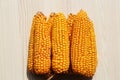 Delicious ripe corn cobs on white wooden table, top view Royalty Free Stock Photo