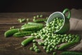 Delicious ripe green peas lying on a wooden table. Royalty Free Stock Photo