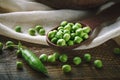 Delicious ripe green peas lying on a wooden table. Royalty Free Stock Photo