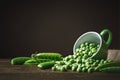 Delicious ripe green peas lying on a wooden table. Royalty Free Stock Photo