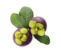 Delicious ripe mangosteens and green leaves on white background, top view