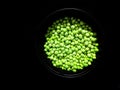 Delicious ripe peas green peas lying on a black table as package design element. Fresh crop.India
