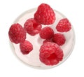 Delicious ripe raspberries falling into bowl with yogurt on background, top view Royalty Free Stock Photo