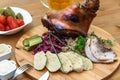Delicious roast pork knuckle with rosemary, pepper, garlic, mustard and spices in the baking dish Royalty Free Stock Photo