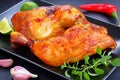 Roasted chicken legs on black plate Royalty Free Stock Photo