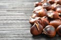 Delicious roasted edible chestnuts on black wooden table, closeup. Space for text Royalty Free Stock Photo