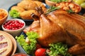 Delicious roasted turkey for traditional festive dinner on table