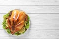 Delicious roasted turkey on wooden table, top view.