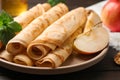 Delicious rolled thin pancakes on wooden table, closeup