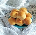 Delicious round small buns on a blue plate